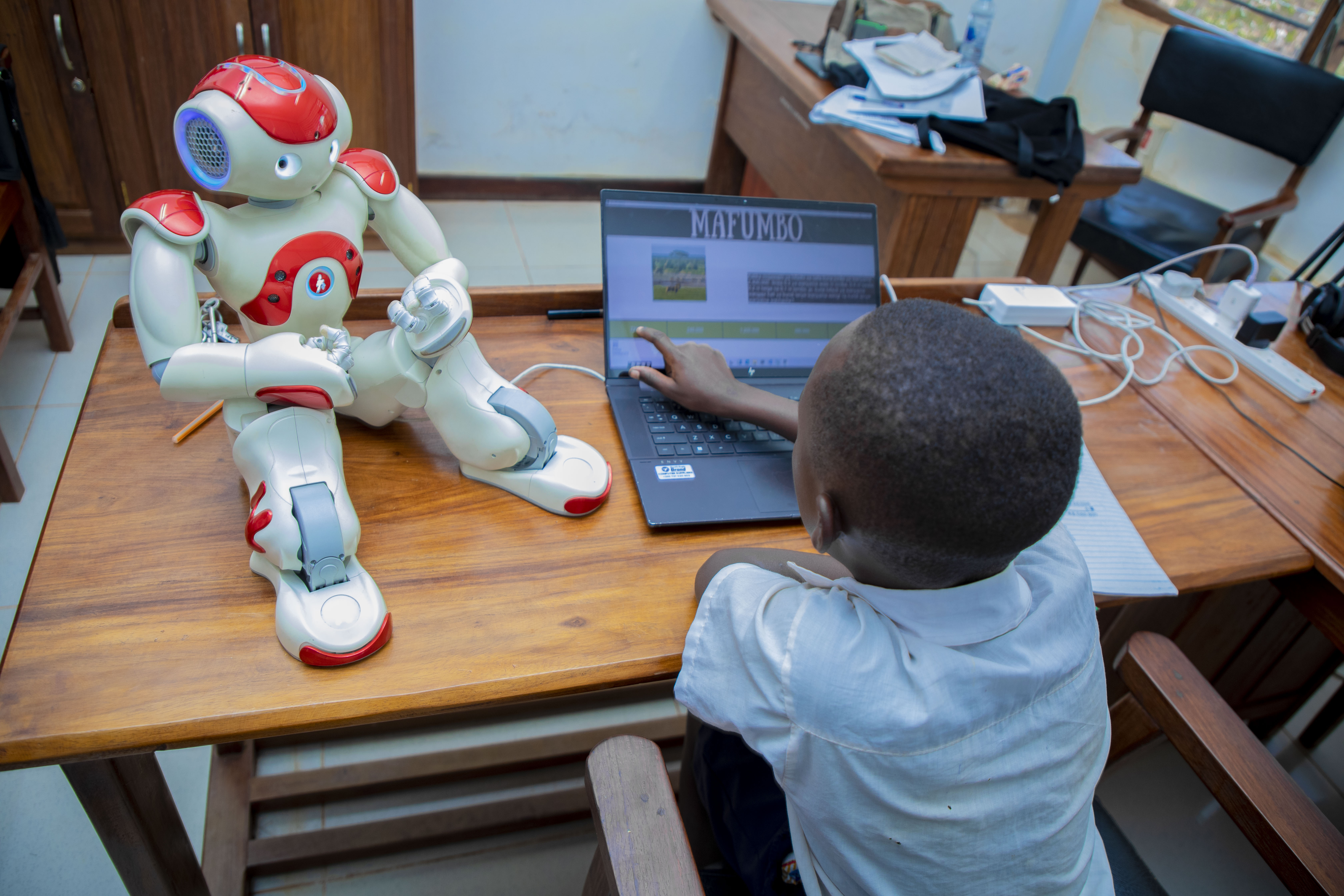 The Nao robot engaged with a student in a STEM activity.